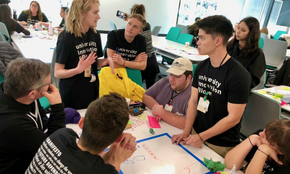 Engineering students and faculty gathered around table at Google