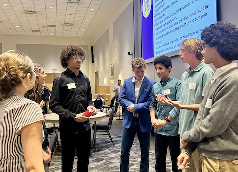 six high school students standing and talking