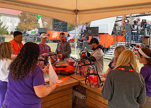 students stuffing college game day bags