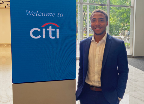 Jordan Lucas beside Citi Bank sign 