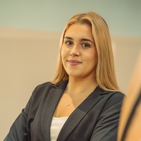 Professional portrait of Kate McKee wearing a blazer, exuding confidence and poise.
