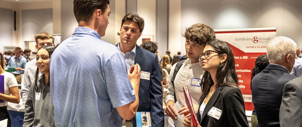Students talking with a recruiter at Meet the Firms