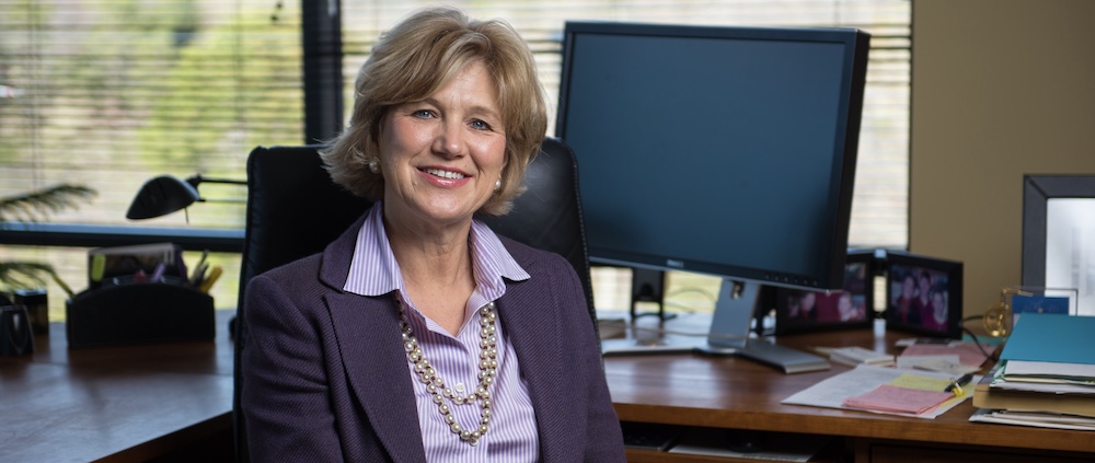 Portrait of Leslie Gilliam seated at an office desk