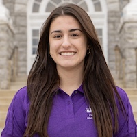 Professional headshot of Alexis Johnson in a purple shirt.