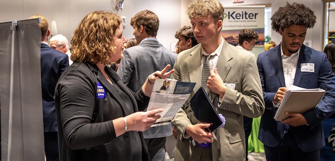 students at Meet the Firms speaking with a recruiter