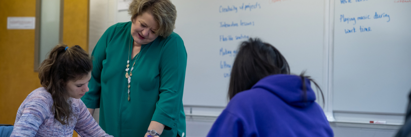 professor working with students at table