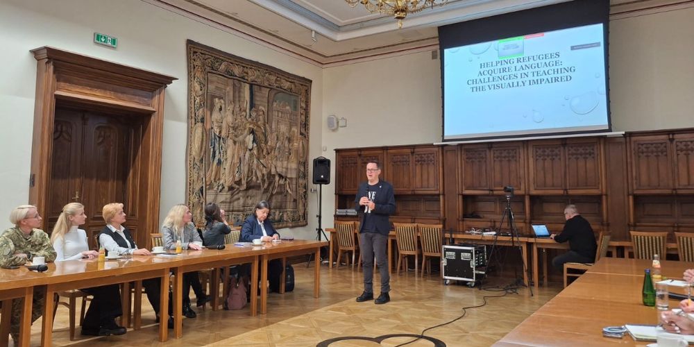Group of people standing around conference table