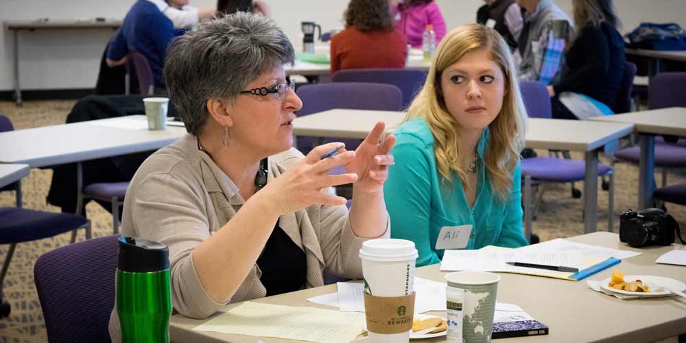 Lori Britt with students at the Students as Neighbors civic engagement event