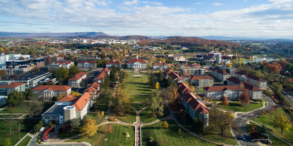 Aerial shot of the JMU campus with the Shenandoah Valley mountains in the background