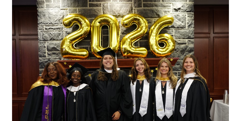 JMU students pose for a picture at graduation