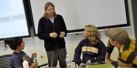 Professor Pete Bsumek meets with students