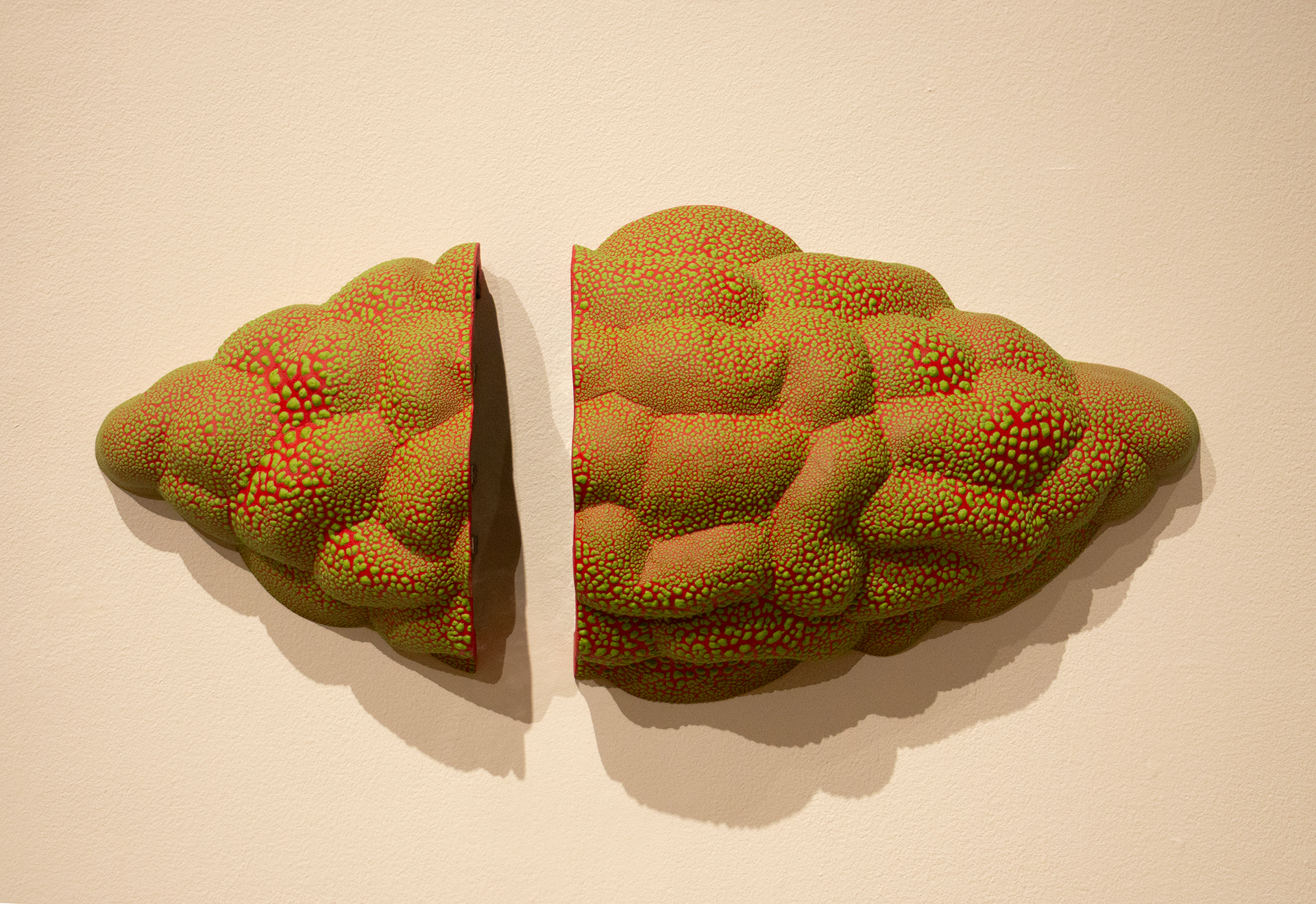ceramic artwork with green and orange bubble texture