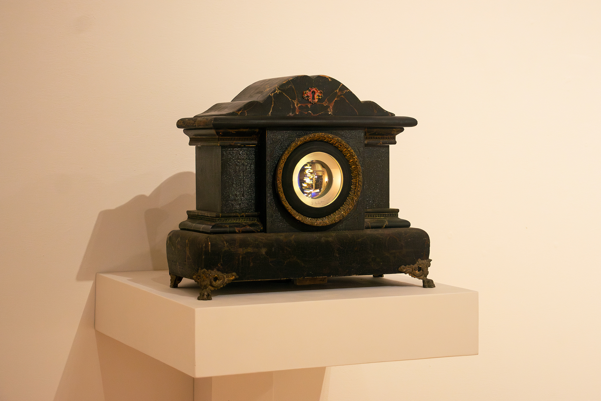 Victorian clock case with lighted rotating sculpture inside