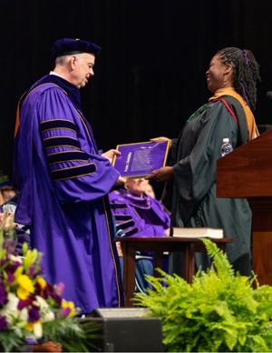 Lauren K. Alleyne presents framed broadside to JMU President James Schmidt