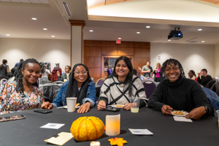 Students and a professor in thanksgiving dinner 2025