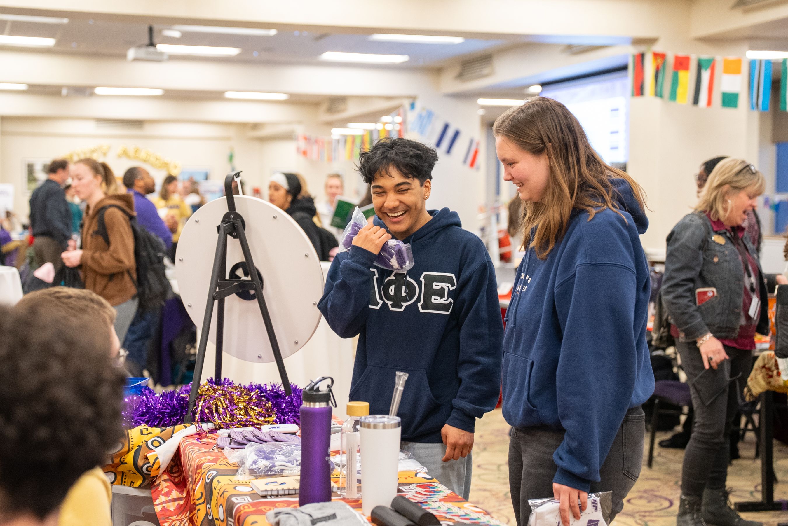 Student laughing and receiving a gift from spinning wheel