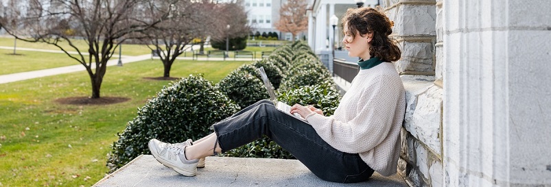 Student on laptop outside