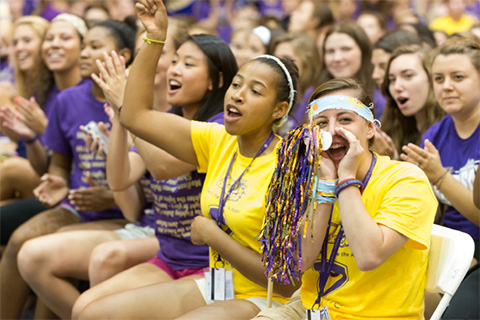 Students in purple and gold cheering
