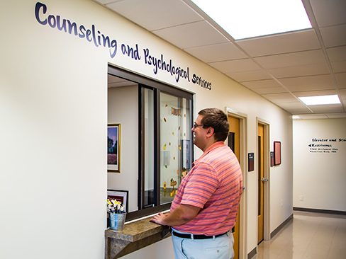 Client checking in at the CAPS Clinic Reception Area