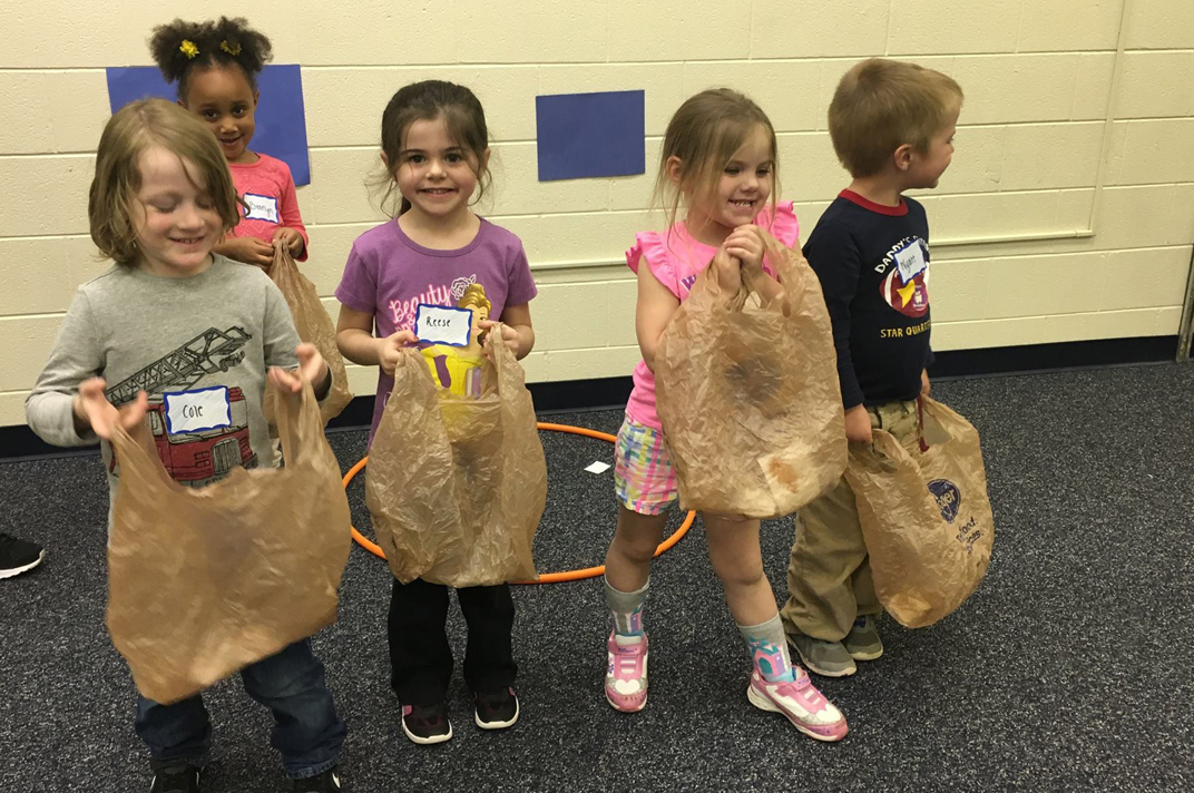 children holding bags of goodies from healthy kids