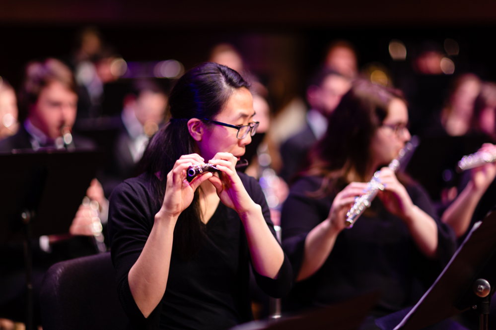 Flute player performing in wind ensemble