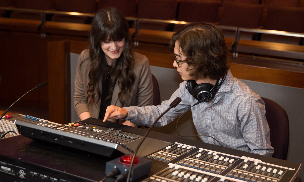 Two students at a mixing board