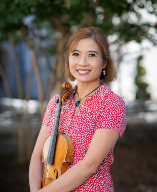 Woman smiling and holding violin