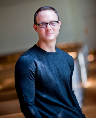 Man wearing glasses smiling at camera