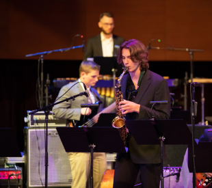 Saxophonist performing with ensemble