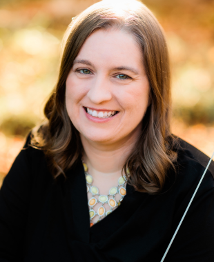 Woman smiling with conducting baton