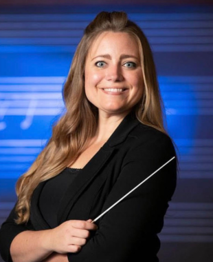 Woman holding conducting baton and smiling at camera
