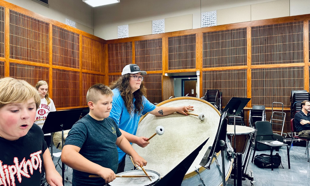 Students playing bass drum and snare drum