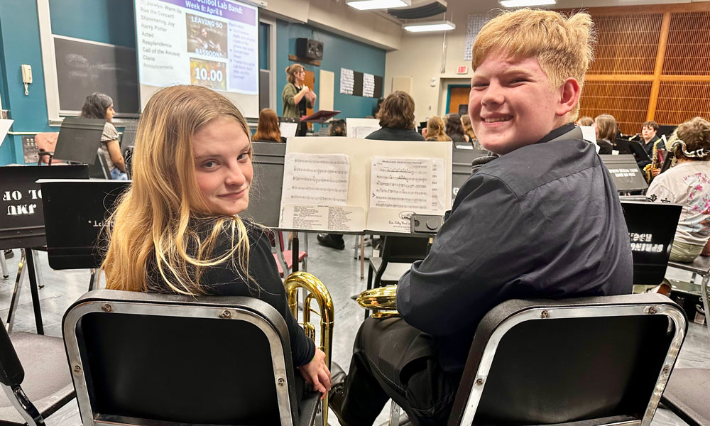 Two students turned and smiling