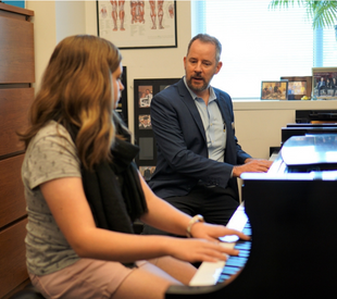 Piano student taking piano lessons