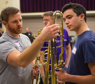 Trombone student looking at instrument