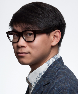 Asian man turned to the left facing camera.