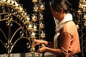 Photo of JMU student lighting a candle to honor Dr. Martin Luther King, Jr.