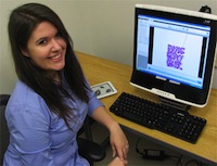 Photo of JMU honors student Leah Hartman Densmore in front of a computer.
