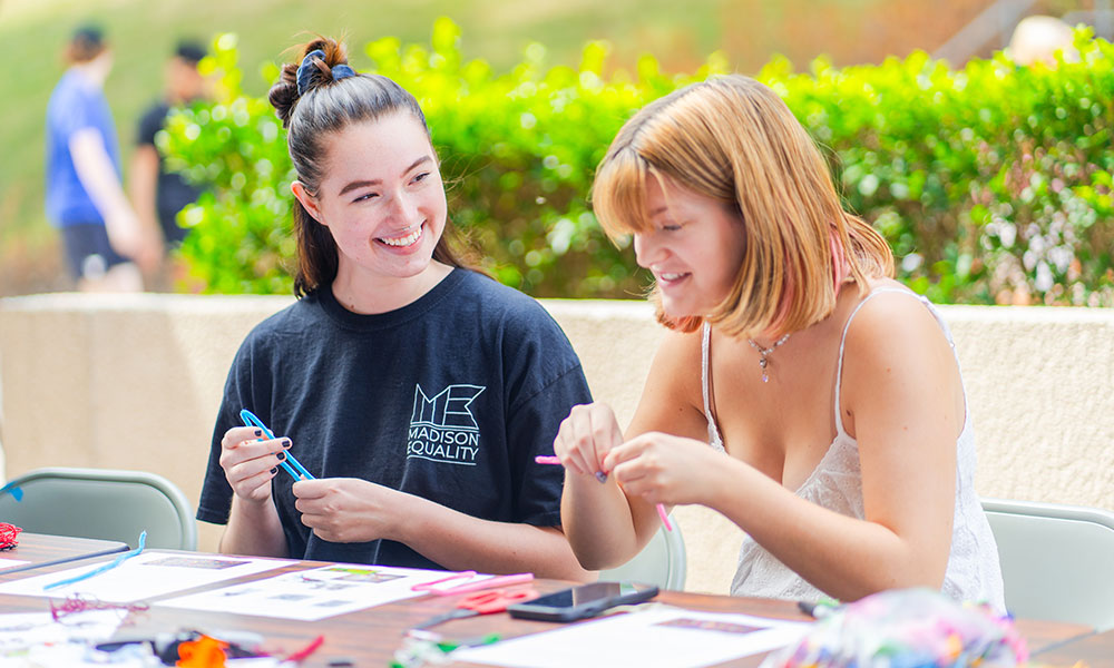 Two female students working on internationally-focused crafts