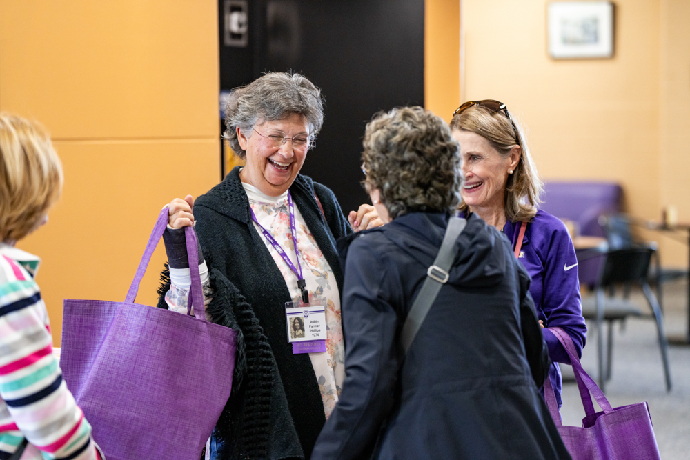 Alumni laughing at check-in