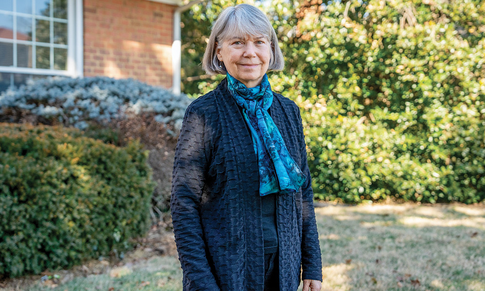 Portrait of Dr. Suzanne Fiederlein in the front yard of JMU's Funkhouser House taken by Rachel Holderman