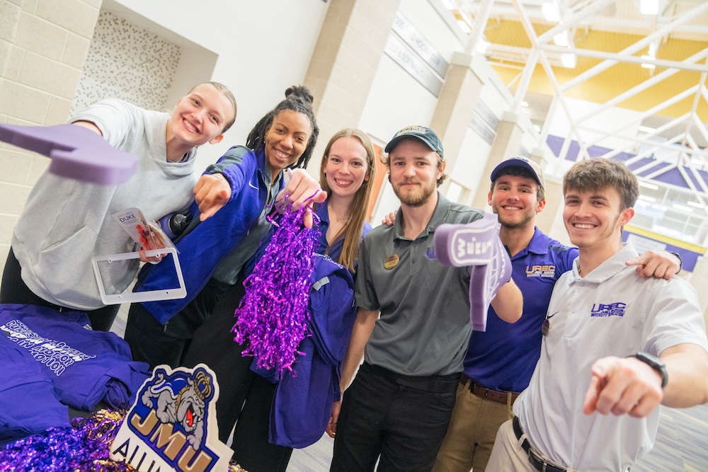 Students and staff having fun and pointing at the camera in UREC