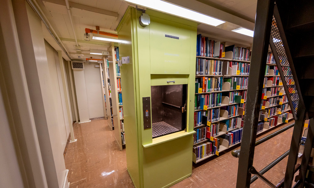 The original library’s structural stacks of books in low-ceilinged levels.