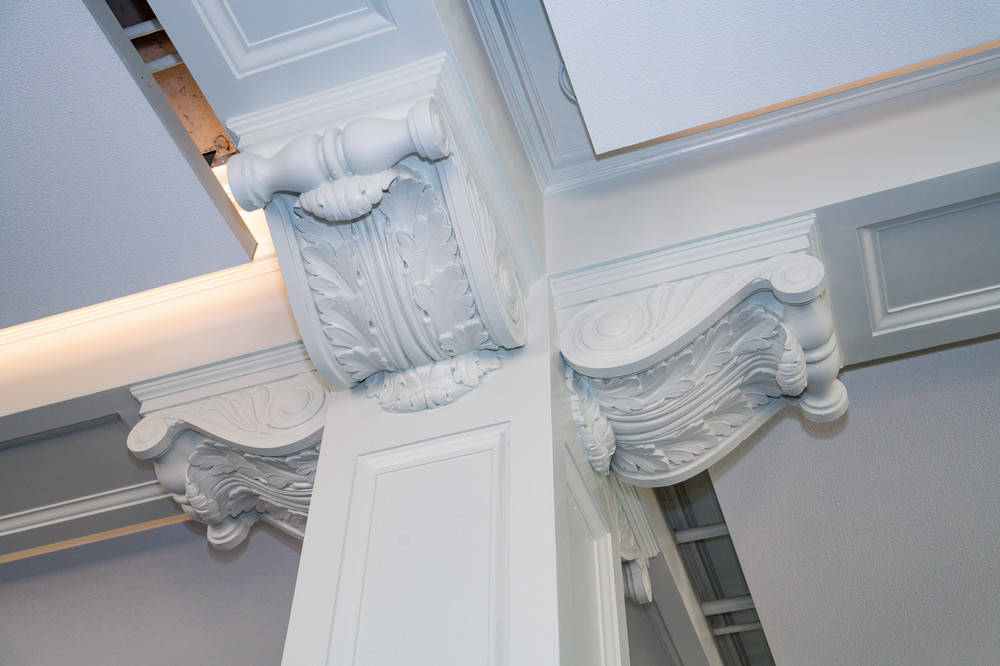 The restored plaster column brackets after completion in 2026.