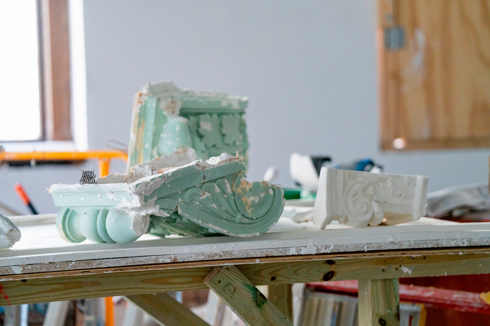 The plaster column brackets as they were being restored in 2024.
