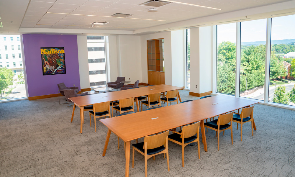 The Furious Flower Poetry Center’s Gwendolyn Brooks Reading Room features long meeting tables, casual seating, and walls of windows.