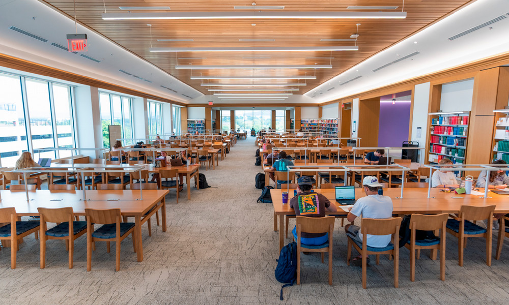 Students study at long tables in the Grand Reading Room on the third floor of the Jones Wing.