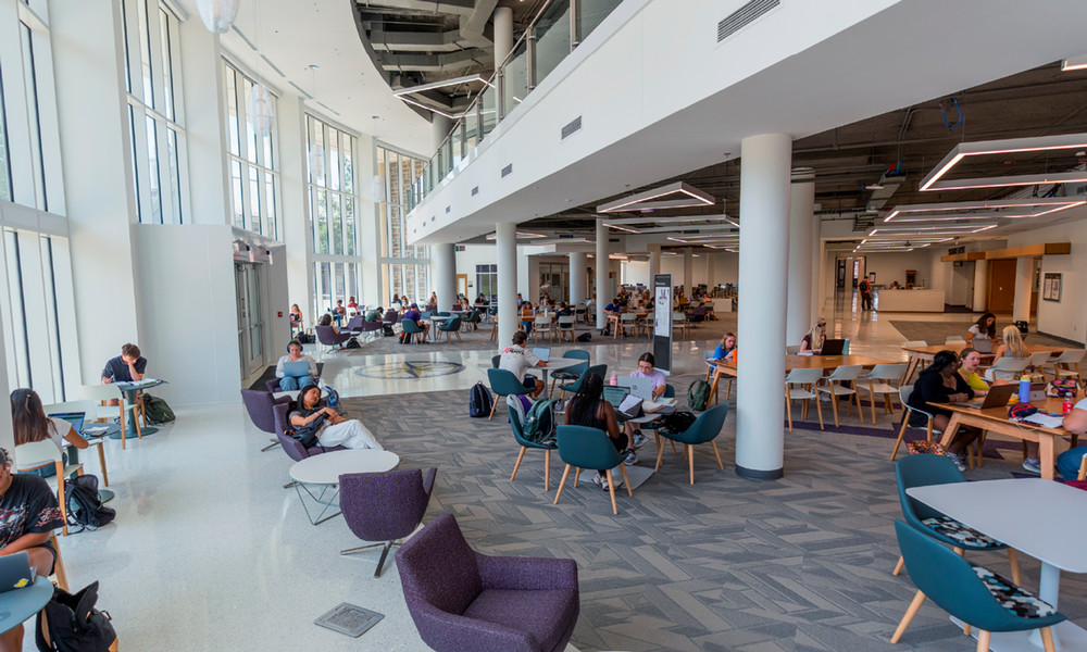 The interior study space, pictured in 2026, features natural light, high ceilings, and a variety of furniture.