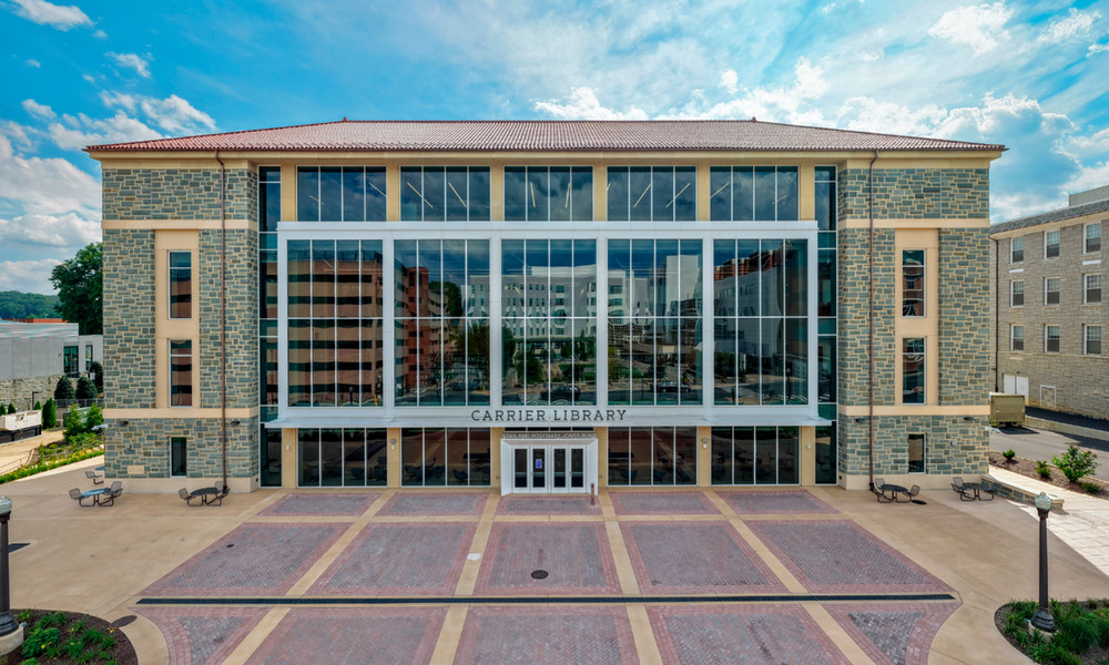 The entrance to the Stan and Rosemary Jones Wing shows off a three story glass wall of windows, bound by traditional bluestone.