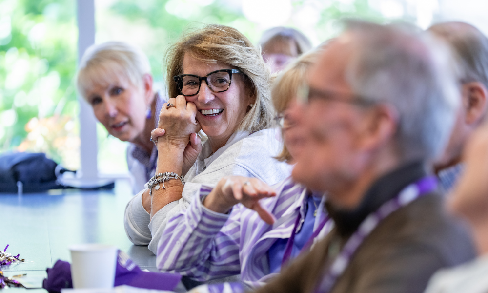 Bluestone reunion attendee, Nancy Moyers and two people to her either side sitting and laughing.